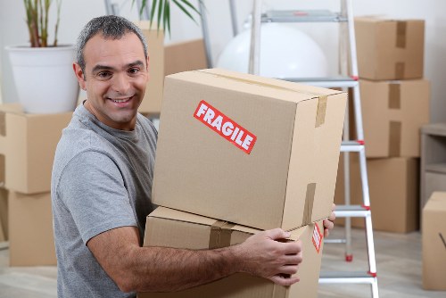 Mover lifting a box using correct manual handling technique