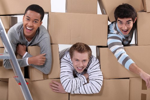 Movers preparing equipment and safety checks before a house move