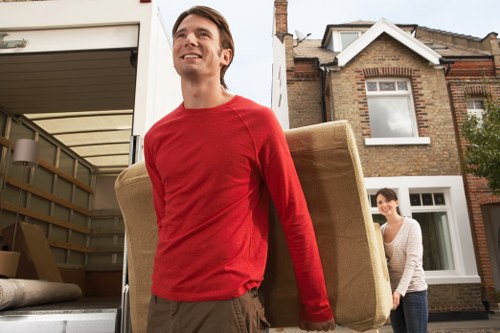 Removal crew moving furniture through a Waterloo property entrance