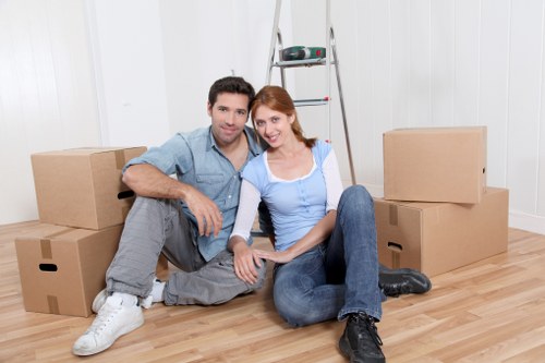 Professional movers packing household items in Waterloo apartment